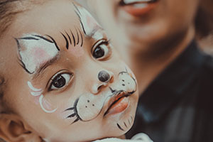Child with cat face paint.