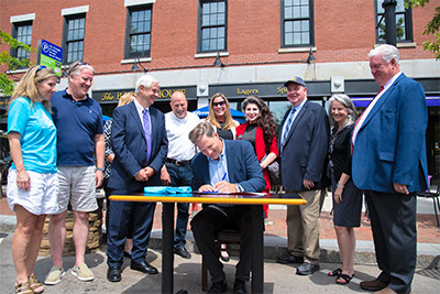 another photo of Governor Sununu signing SB3
