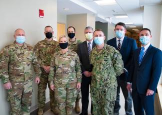 Members of the Department of Defense team with Greg Baxter, President of Elliot Health System, Kevin Desrosiers, Chief Medical Office of Elliot Hospital and Elliot Medical Group Acute Care Services and Vice President of Medical Affairs, and Tate Curti, Chief Operating Office of Elliot Hospital
